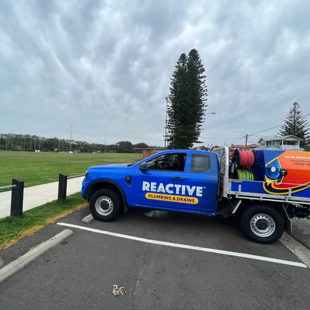 Reactive plumbing worker in hamilton sitting in car
