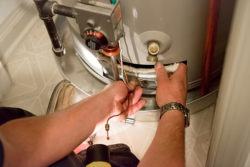 man repairing a water heater